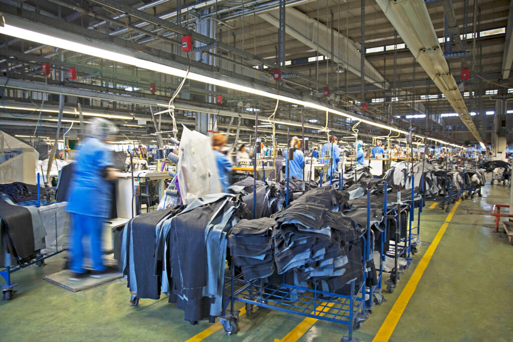 Workers inside a factory producing jeans